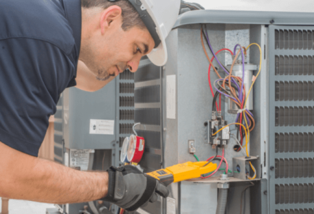 Image of a man working on HVAC equipment