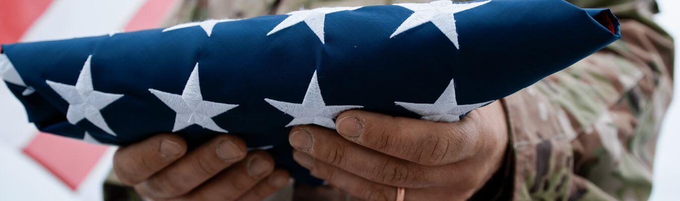 image of a veteran holding a united states flag