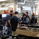 skilled trades workers in diesel mechanic lab observing the instructor