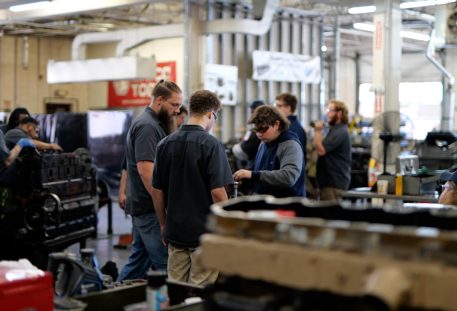 skilled trades workers in diesel mechanic lab observing the instructor