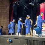 NATS graduates walking across stage and accepting diploma