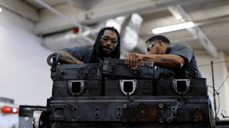 Two students leaned over trunk