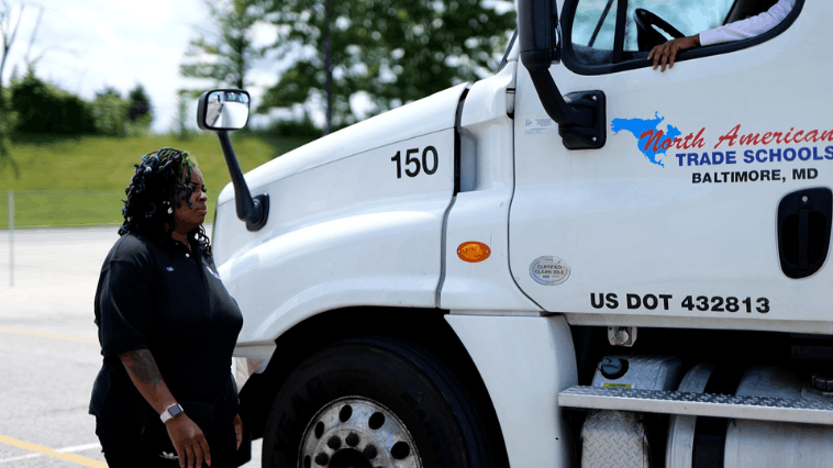 Closeup of NATS white semi truck cab with instructor standing in front