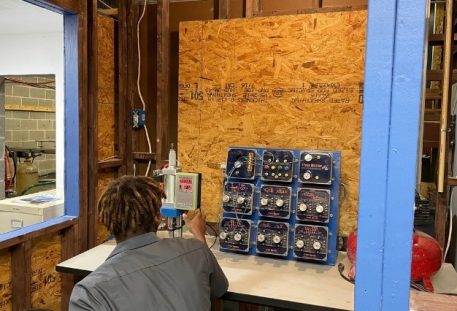 Student working on an electrical panel at trade school