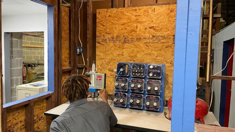 Student working on an electrical panel at trade school