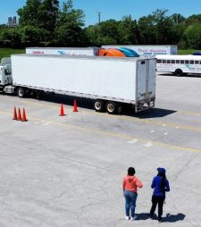 Drone view of CDL training yard at NATs with two people standing near the semi truck
