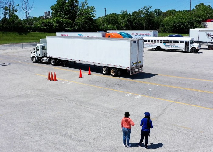 Drone view of CDL training yard at NATs with two people standing near the semi truck